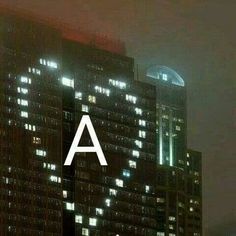 a tall building with the letter a on it's side in front of other buildings