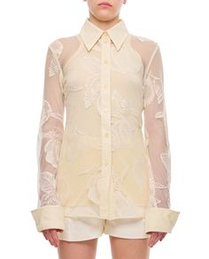 This Sportmax lace shirt features a pointed collar and intricate see-through floral patterns, making it suitable for both elegant and casual occasions. The refined buttoned closure and cuffs add to its feminine charm.

- Pointed collar  
- See-through floral patterns  
- Buttoned closure  
- Cuffs Designer White Shirt With Button Cuffs, Luxury White Collared Blouse, White Blouse With Concealed Placket And Fold-down Collar, Designer White Tops With Button Cuffs, Designer White Top With Fold Down Collar, Spring Tops With Collar And Concealed Placket, Designer Lapel Collar Top For Spring, White Blouse With Concealed Placket For Spring, Designer Top With Lapel Collar For Spring