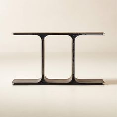 a black table with two metal legs and one is standing on top of the other