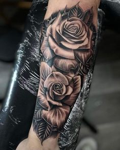 a black and white rose tattoo on the arm