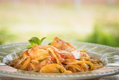 pasta with shrimp and tomato sauce in a bowl