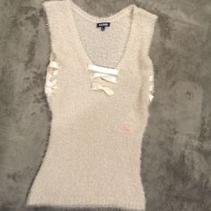 Soft Luxurious Loosely Knit Sleeveless Sweater With Crisscross Satin Ribbon Detail At V Neck Area & On Sides. Very Stretchy Cream With Sparkly Opaque Threads Throughout. Casual Knit Tank Top For Party, Casual Silver Sleeveless Tank Top, Casual Silver Sleeveless Top, Sleeveless Winter Party Top, Sleeveless Party Tops For Winter, Nordstrom Sweaters, Sleeveless Sweater, Satin Ribbon, Colorful Sweaters