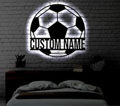 a bedroom with a brick wall and a neon sign that says custom name