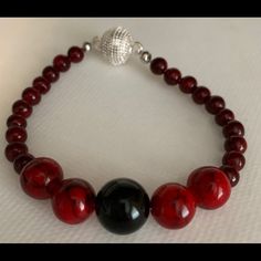 Red Beads With One Black Onyx Bead With Sterling Silver Swarovski Magnet Closure. 8 Inch Red Adjustable Beaded Bracelets For Formal Occasion, Red Adjustable Beaded Bracelets For Formal Wear, Elegant Red Beaded Necklace With Black Beads, Elegant Red Beaded Bracelets For Formal Occasions, Elegant Red And Black Beaded Necklaces, Elegant Red Beaded Bracelet For Formal Occasions, Elegant Red And Black Beaded Necklace, Handmade Formal Beaded Bracelets, Formal Handmade Beaded Bracelets