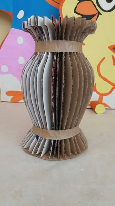 an origami vase made out of magazines