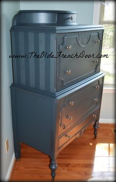 an old dresser is painted blue and silver