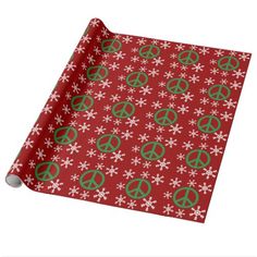 a red wrapping paper with green peace signs and snowflakes on the bottom,