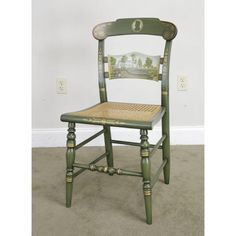 a green wooden chair sitting on top of a carpeted floor next to a wall