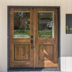 the front door to a home with two double doors and sidelights on either side