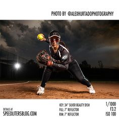 a female baseball player holding a ball on top of a field in front of a cloudy sky