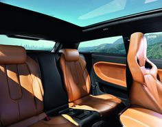 the interior of a car with tan leather and black trim, including two rows of seats