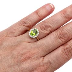 Want to create a different look, then you can go for this special Diamond Oval Peridot Ring. The ring is featuring the 4.28 ct Peridot diamonds surrounded by white diamonds crafted in Yellow Gold. This Unique Gemstone Ring will give you a statement look to your jewelry. Get this ring at the most reasonable price. Peridot Engagement Rings, August Birthstone Ring, Green Gemstone Ring, August Birthstone Jewelry, Peridot Stone, August Birthstone, Peridot Ring, Peridot Gemstone, Zircon Ring