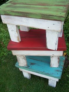 two wooden benches sitting on top of each other in the grass