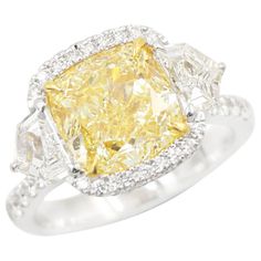 From Emilio Jewelry, a well known and respected wholesaler/dealer located on New York’s iconic Fifth Avenue, The focal point of this ring is the magnificent Gia Certified Natural Fancy Yellow Diamond in the center weighing alone over 5 carats. This diamond is very rare because it has a clarity rating of Flawless. See the Emilio Difference! Please inquire for more images, certificates, details, and any questions. Please contact us to see this piece on a zoom meeting live. Our speciality is in the Rare Diamond Rings, Emilio Jewelry, Fancy Yellow Diamond Ring, The White Room, Yellow Diamond Ring, Zoom Meeting, Yellow Diamond Rings, Fancy Yellow Diamond, White Room