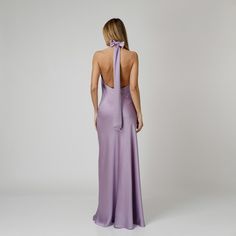 A captivating blend of elegance and allure, our Lylia Open Back Halter Dress exudes undeniable charm. Tailored with a flattering bias cut from lavender double silk satin, it drapes gracefully over the silhouette. The halter neckline delicately frames the shoulders, while the revealing back adds a note of sensuality. For a playful and feminine look, you can transform the silk tie neck into a chic bow, or you can let it drape loosely, adding a touch of laid-back sophistication to your ensemble.  W Elegant Mauve Midi Dress For Evening, Elegant Mauve Evening Midi Dress, Elegant Lavender Party Dress, Elegant Lavender Maxi Dress For Evening, Elegant Purple Maxi Evening Dress, Elegant Lavender Midi Dress For Formal Occasions, Elegant Purple Midi Dress With Fitted Bodice, Elegant Lavender Evening Dress For Formal Events, Elegant Mauve Midi Dress