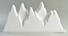 three white mountains are shown against a gray background