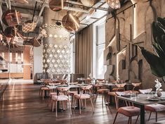 an empty restaurant with wooden tables and chairs