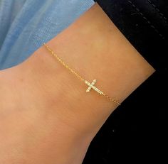 Our Esther Dainty Diamond Cross Bracelet is a glimmering beacon of faith. Stylish and elegant, this bracelet embodies the beauty of His grace. Perfect to shine on its own but sophisticated enough to add to a stack. The intentional delicacy of this design makes for the heartfelt gift of a child's first piece of fine jewelry or an adult's everyday dainty wear. Metal: 18k White Gold / 18k Yellow Gold / 18k Rose Gold Round Brilliant Cut Natural Diamonds: Approx. 0.10 ctw G Color and SI1-2 Clarity Diamonds Length: 7 inches at the longest. ﻿Adjustable sliding bead to provide options for smaller wrist size. Closure: Lobster clasp Measurements: Approx. 11.7mm length x 5.9mm width Looking for a different size? Please email us. Collar Chain, Mens Engagement, How To Make Rings, Diamond Cross, Bridal Bands, Jewelry Lookbook, Band Bracelet, Choker Collar, Cross Bracelet