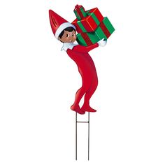 an elf is holding a christmas present on a stick