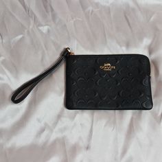 Coach Wristlet Black Rectangular Clutch With Wrist Strap, Black Clutch With Wrist Strap Gift, Elegant Handheld Clutch With Wrist Strap, Black Pouch With Wrist Strap For Daily Use, Coach Black Wristlet With Zipper Pouch, Black Pouch Wristlet With Zipper Closure, Black Pouch Wristlet With Wrist Strap, Black Zipper Pouch Wristlet, Black Clutch Wristlet For Formal Occasions