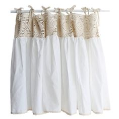 white curtains with lace trims hanging on a rod