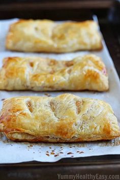 three pastries sitting on top of a baking sheet