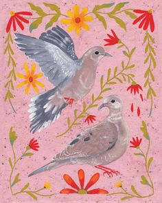 two birds sitting on top of a pink surface with flowers and leaves around the edges