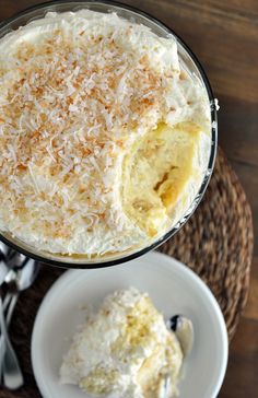 a dessert dish with coconut on top and a spoon in the bowl next to it