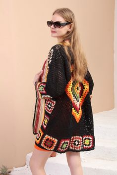 a woman is walking down the stairs carrying a crocheted bag