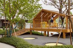 children's play area with swings, slides and trees