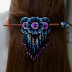 a close up of a woman's hair with beads on it