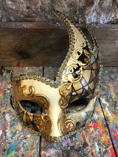 "Venetian Mask Columbine,Dove Mask,Venice mask,Carnival mask,Halloween mask,party mask,columbine mask,Venetian mask,carnival mask,carnival mask,decoration mask,dove. Original Venetian Mask Colombina, hand painted embellished with gold leaf, decoration with stucco and acrylic colors. -Material/Resin Made in Italy hypoallergenic and non-toxic. -Dimensions/15x18 Unisex -History of the mask/ \"Colombina\" is an ancient mask dating back to the 15th century. She represents a cunning and lying servant Gold Fantasy Festival Masks And Prosthetics, Gold Masquerade Mask For Mardi Gras Festival, Gold Venetian Mask For Halloween, Fantasy Masks For Carnival And Festivals, Fantasy Carnival Mask For Festivals, Artistic Masks And Prosthetics For Mardi Gras Carnival, Gold Masks And Prosthetics For Carnival Festival, Artistic Masks For Festivals And Costume Parties, Artistic Masks For Costume Party And Festivals