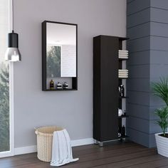 a bathroom with a sink, mirror and towel dispenser on the wall