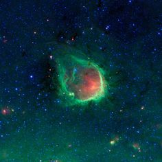 an image of a green and red object in the sky with stars on it's sides