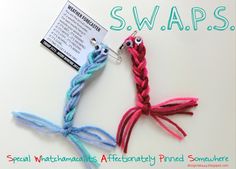 two different colored yarns are tied to each other and the words swaps written on them