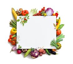 an overhead view of various vegetables surrounding a white sheet with space in the center for text