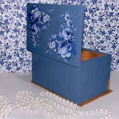 a blue box with flowers painted on it