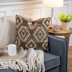 a living room with a couch, coffee table and lamp