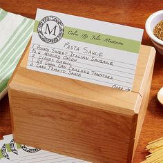 a wooden box sitting on top of a table filled with pasta and other food items