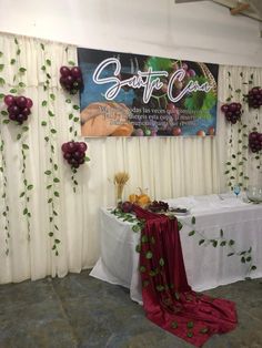 the table is set up for an event with white linens and purple flowers on it