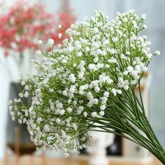 some white flowers are in a vase on a table