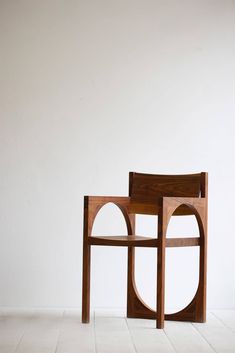 a wooden chair sitting on top of a white floor