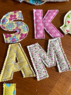 the letters are made out of fabric and have flowers on them