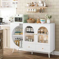 a kitchen with white cabinets and shelves filled with food