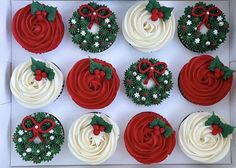 twelve cupcakes decorated with red and white frosting, holly wreaths and mistlet decorations