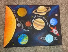 a painting on the floor with planets and stars