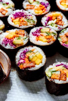 several sushi rolls with different toppings on them