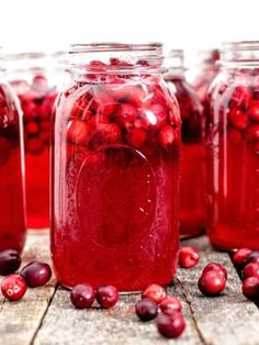 cranberry sauce in mason jars sitting on a wooden table