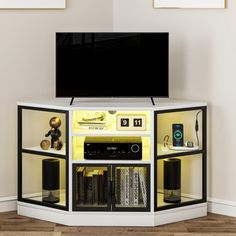 an entertainment center with a flat screen tv and speakers