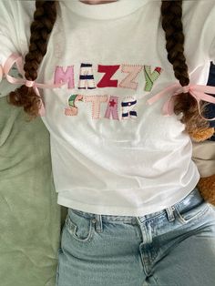 a girl with braids wearing a t - shirt that says mezz star